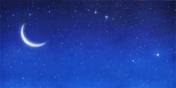 Crescent moon shining in a star-filled night sky with a deep blue gradient.