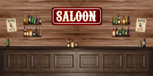 A rustic saloon interior with a wooden bar, bottles on shelves flanking the counter, and a red SALOON sign centered above, plus two Wanted posters on the wall.