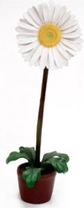 Artificial white daisy in a small terracotta pot with green leaves at the base.