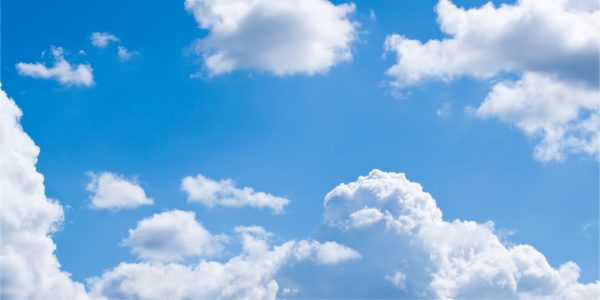 Blue sky with white fluffy clouds scattered across the scene.