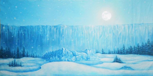 Blue winter landscape with a full moon, snow-covered ground, and evergreen trees in the foreground, softly falling snow.
