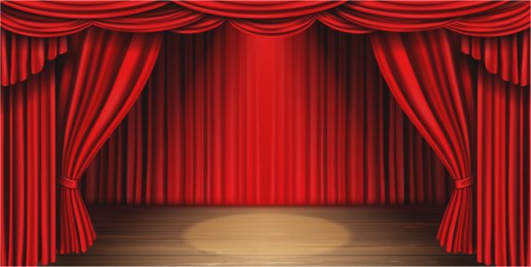The red theater curtains parted to reveal a wooden stage with a spotlight.