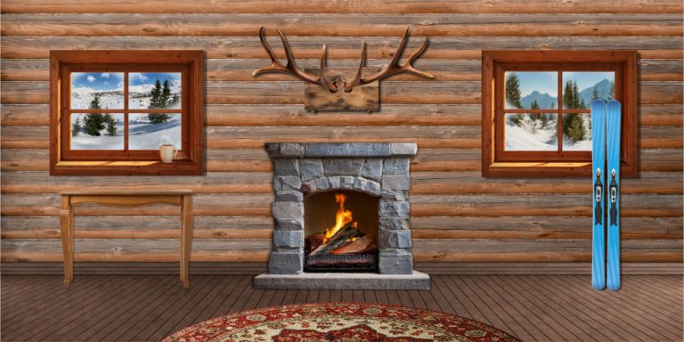 Cozy log cabin living room with a stone fireplace, mounted antlers, snowy window views, and blue skis propped by the wall.